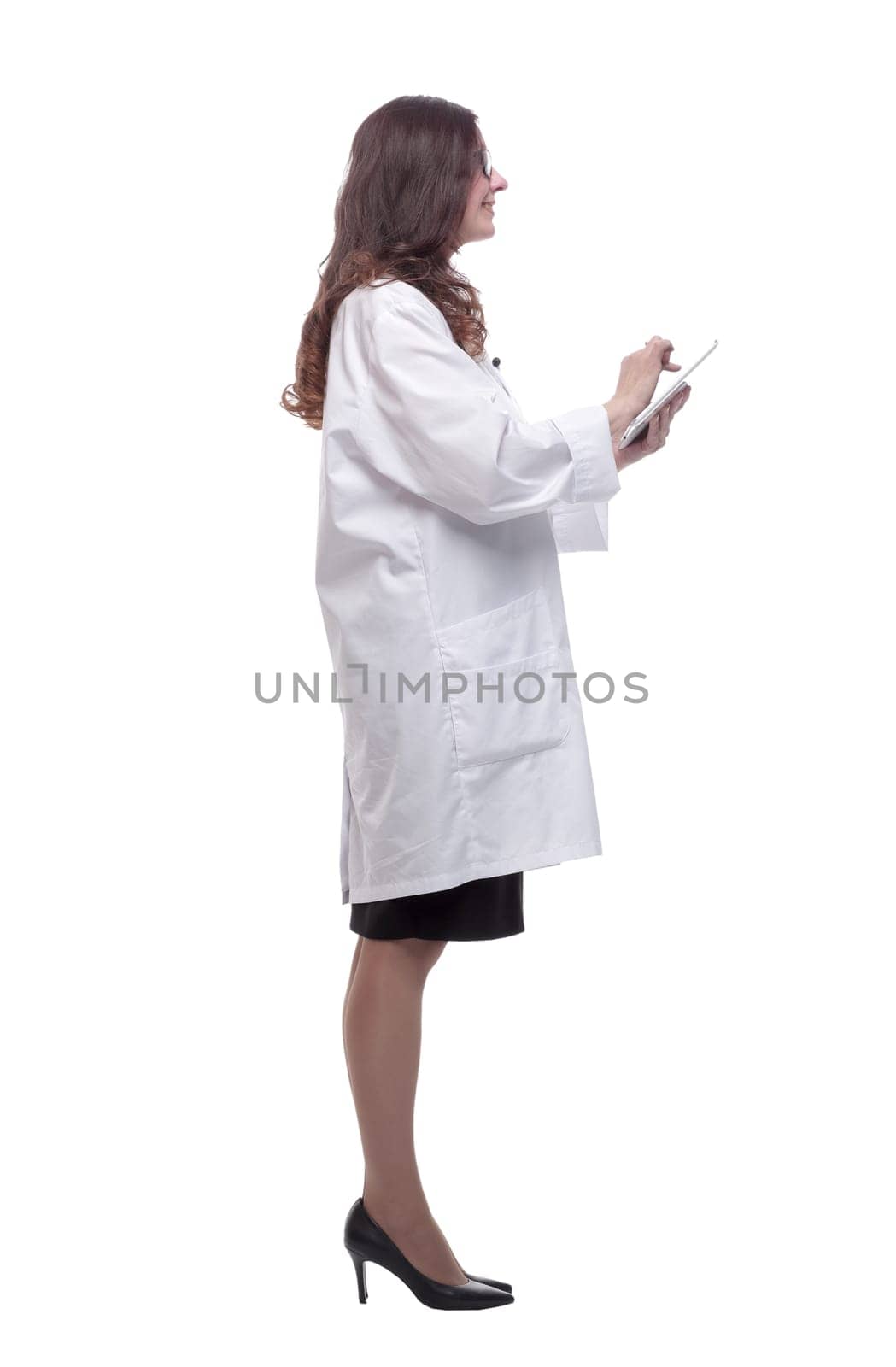 in full growth. female doctor looking at a digital tablet screen . isolated on a white
