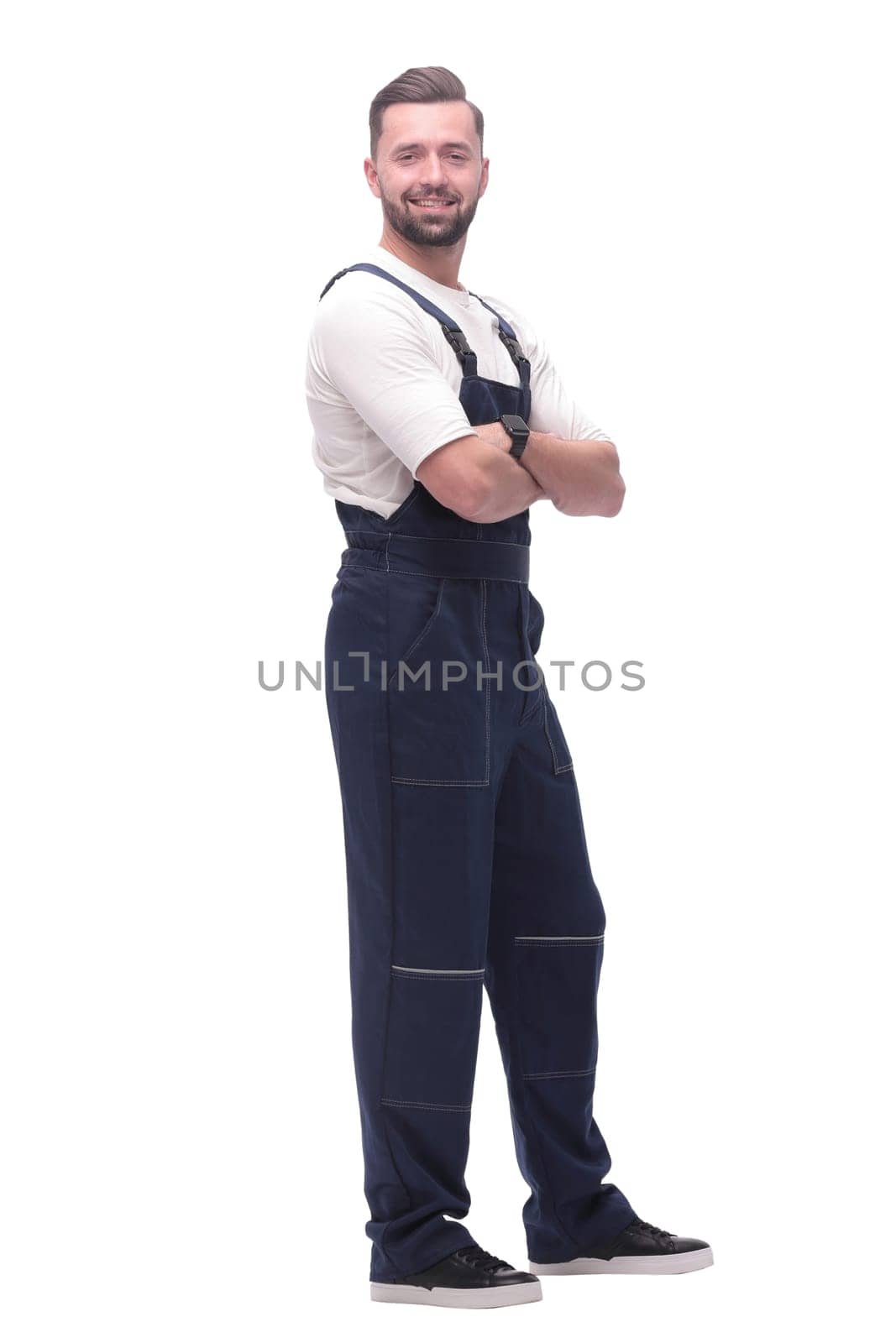 side view. smiling man in overalls looking forward to copy space. isolated on white background