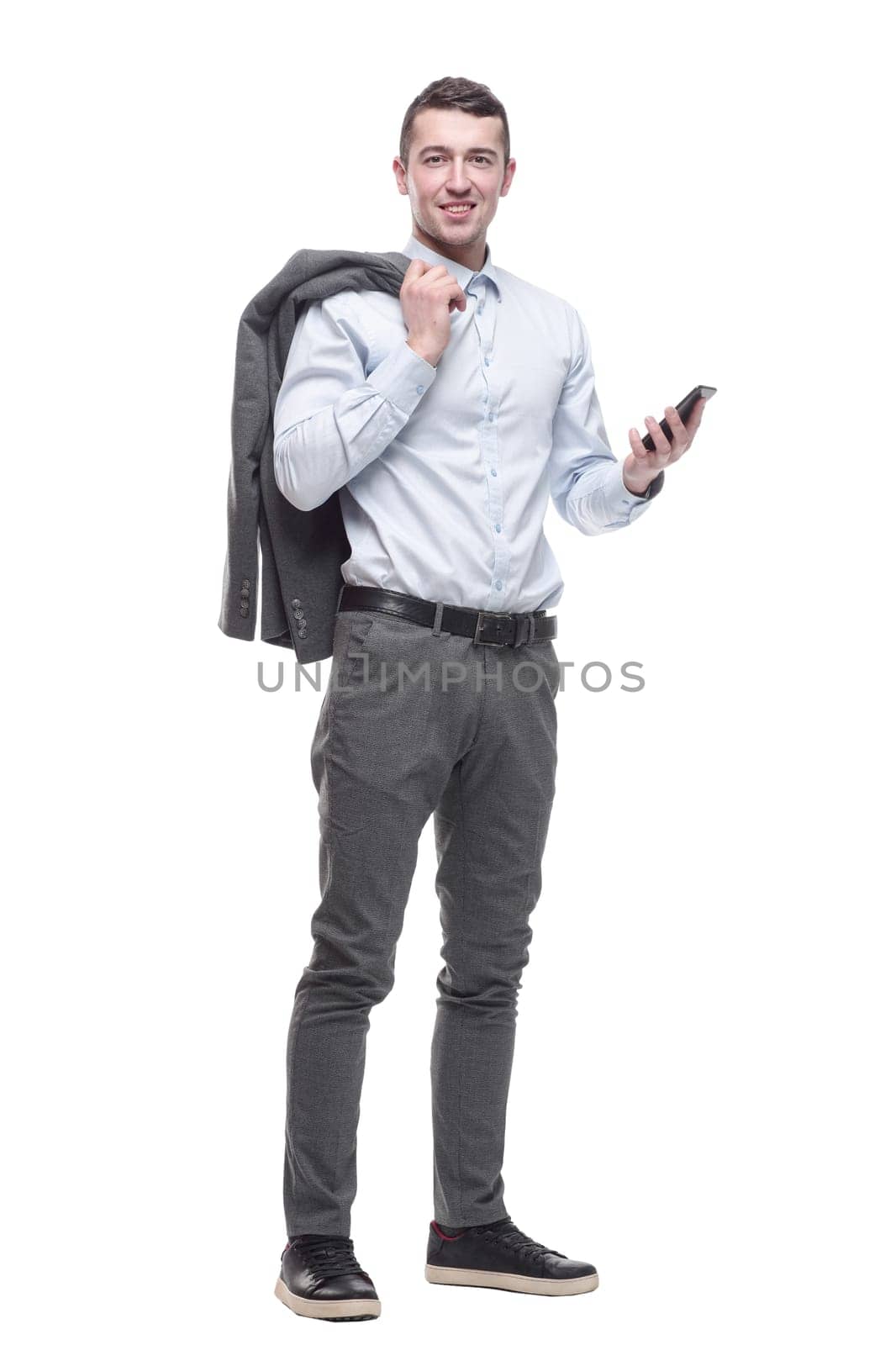 in full growth. smiling business man with a smartphone . isolated on a white background.