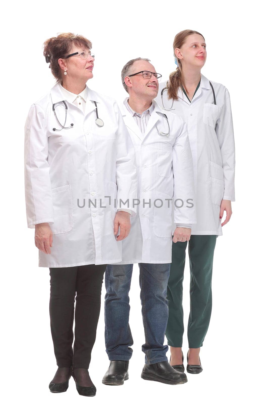 Team of doctors standing arms crossed and smiling at camera. Concept of medical help and confidence