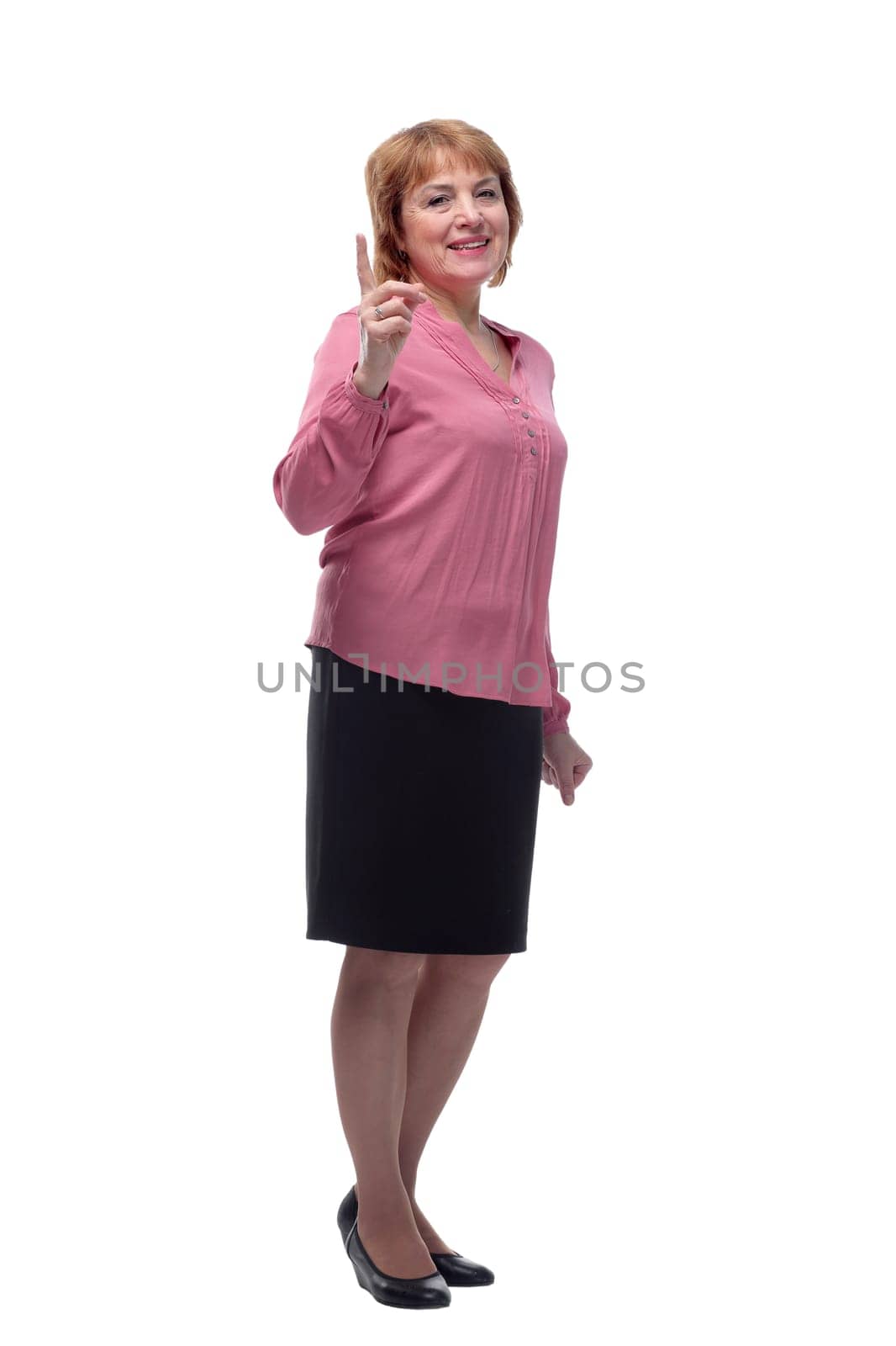 Portrait of a happy senior woman pointing upwards, isolated on a white background. Concept of finding new idea