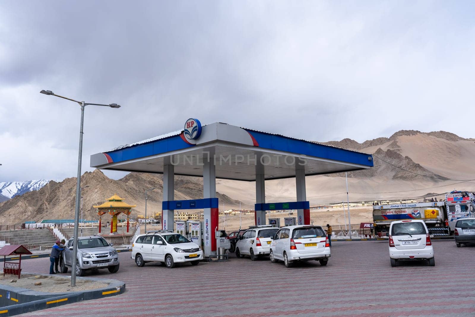 Leh, India - April 06, 2023: Vehicles waiting in line to be refueled at a gas station