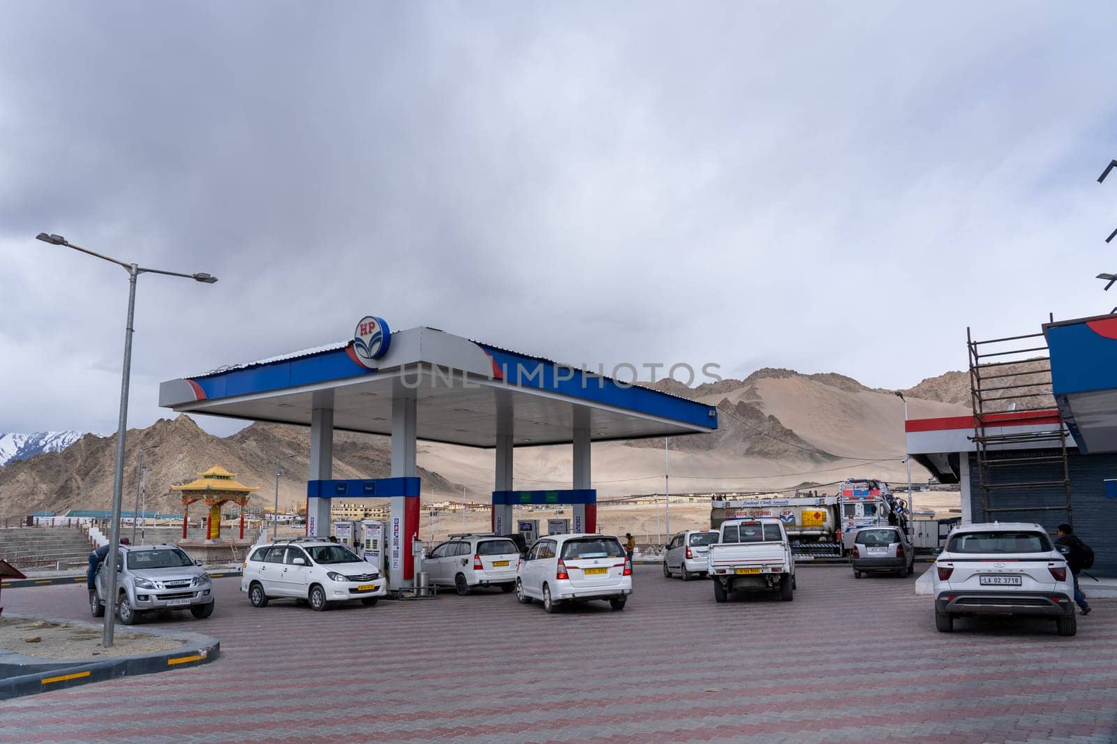 Leh, India - April 06, 2023: Vehicles waiting in line to be refueled at a gas station
