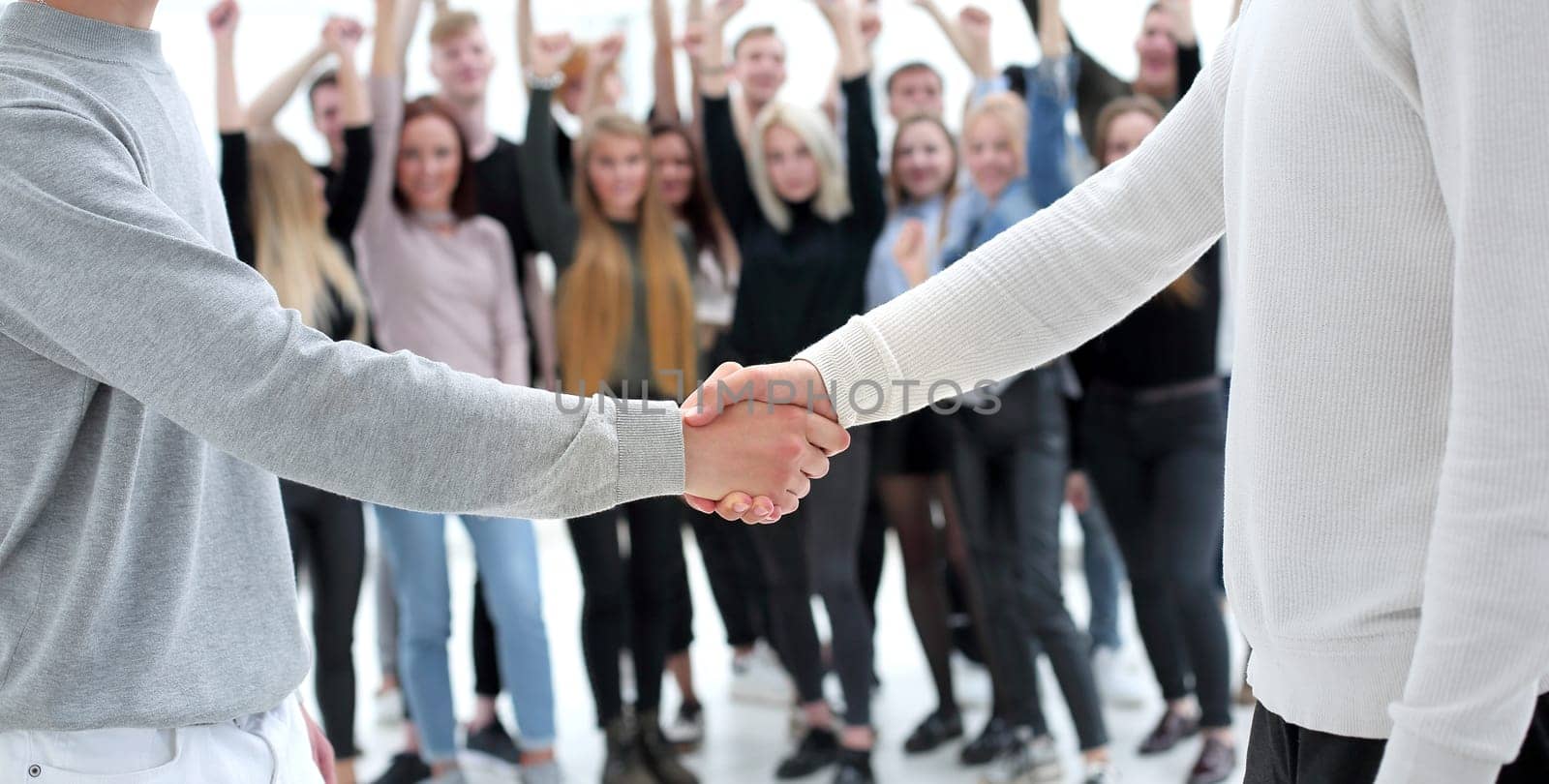 young business people shaking hands with each other by asdf