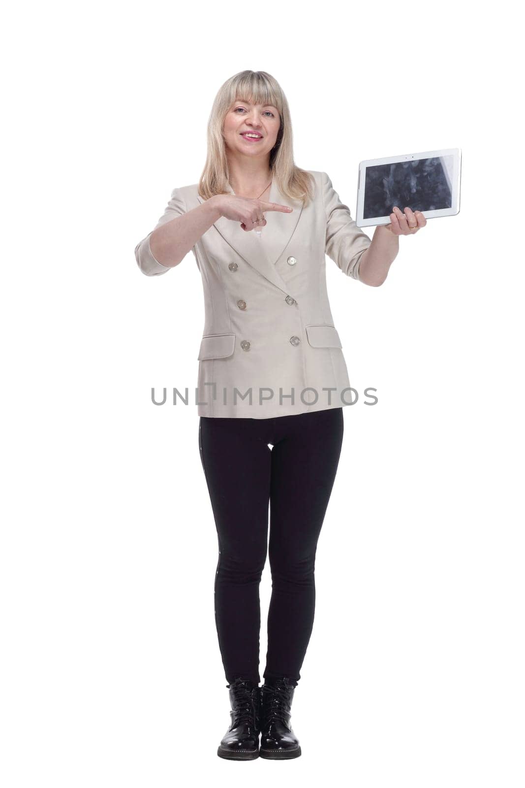 in full growth. attractive woman pointing on her digital tablet . isolated on a white background.