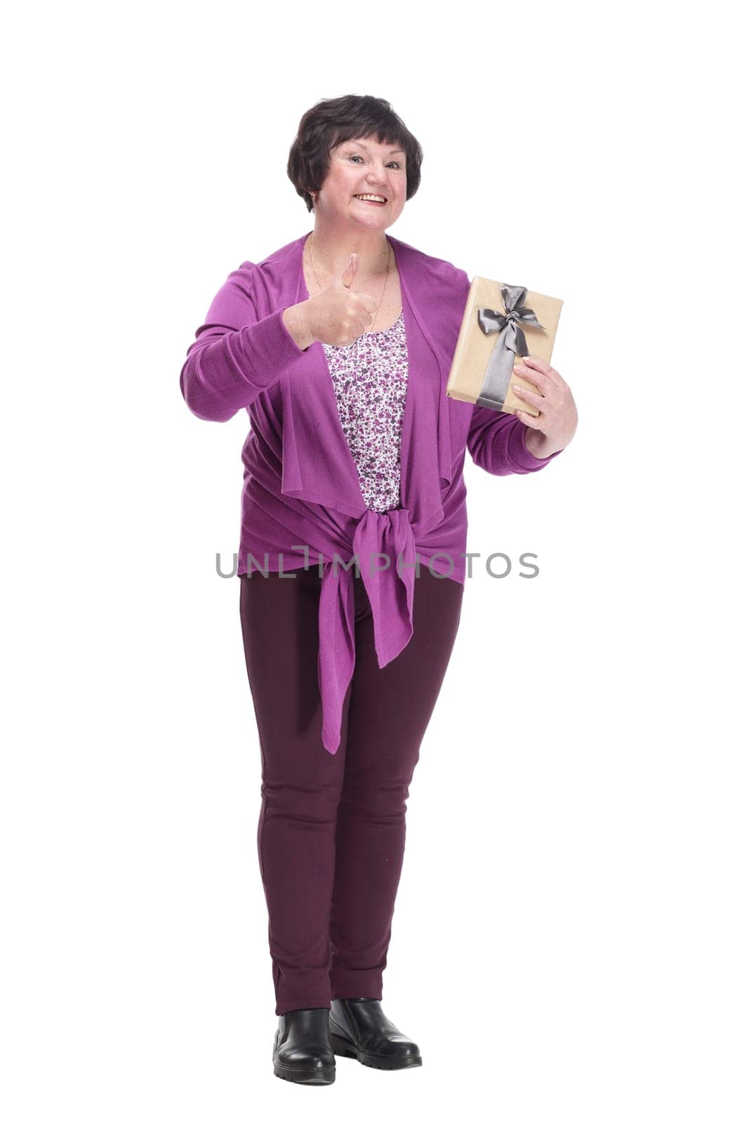 in full growth.happy senior woman with gift box. isolated on a white background.