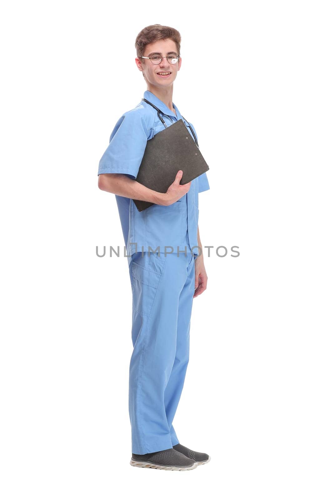 Side view of concentrated male doctor writing reports over white background