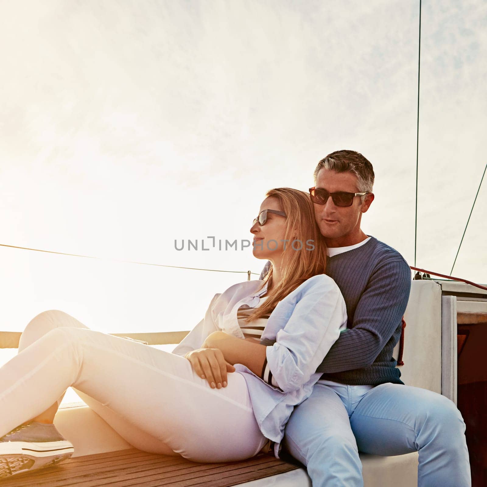 See the world with me. a couple enjoying a boat cruise out on the ocean. by YuriArcurs