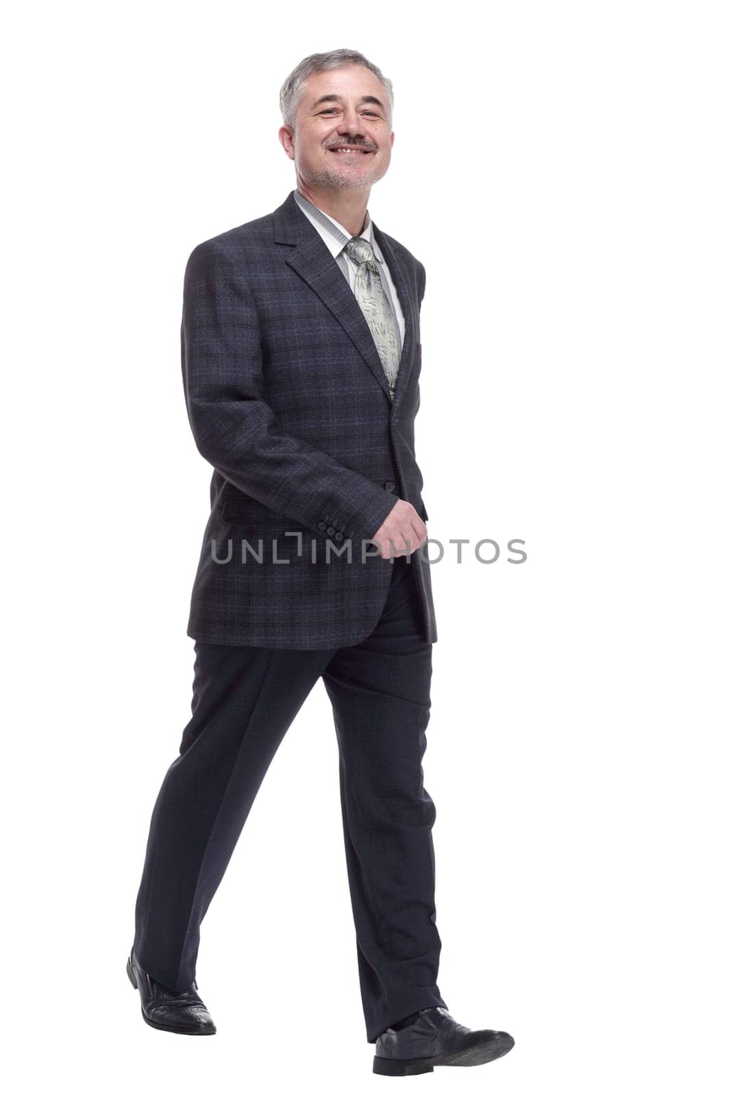 in full growth. confident adult male striding forward . isolated on a white background