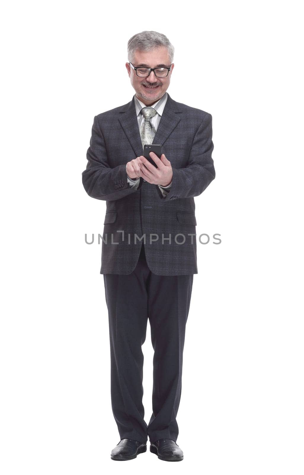 in full growth. smiling elderly man with a smartphone . isolated on a white background