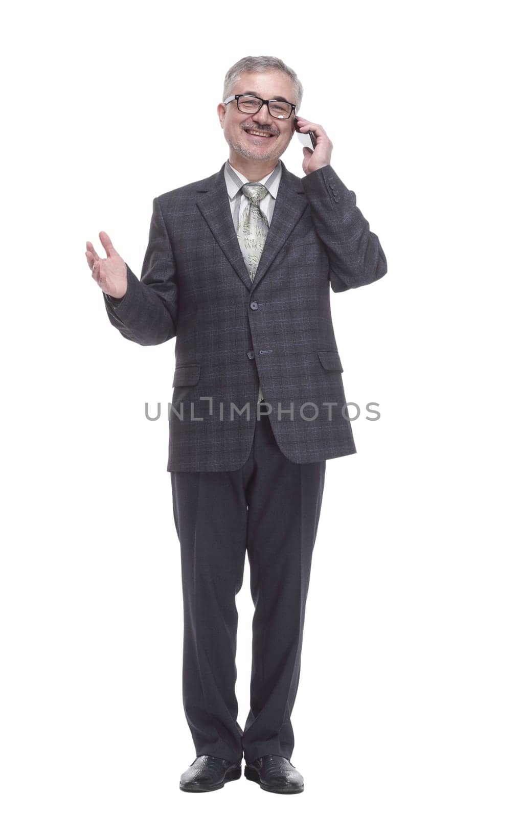 in full growth. smiling elderly man talking on a smartphone . isolated on a white background