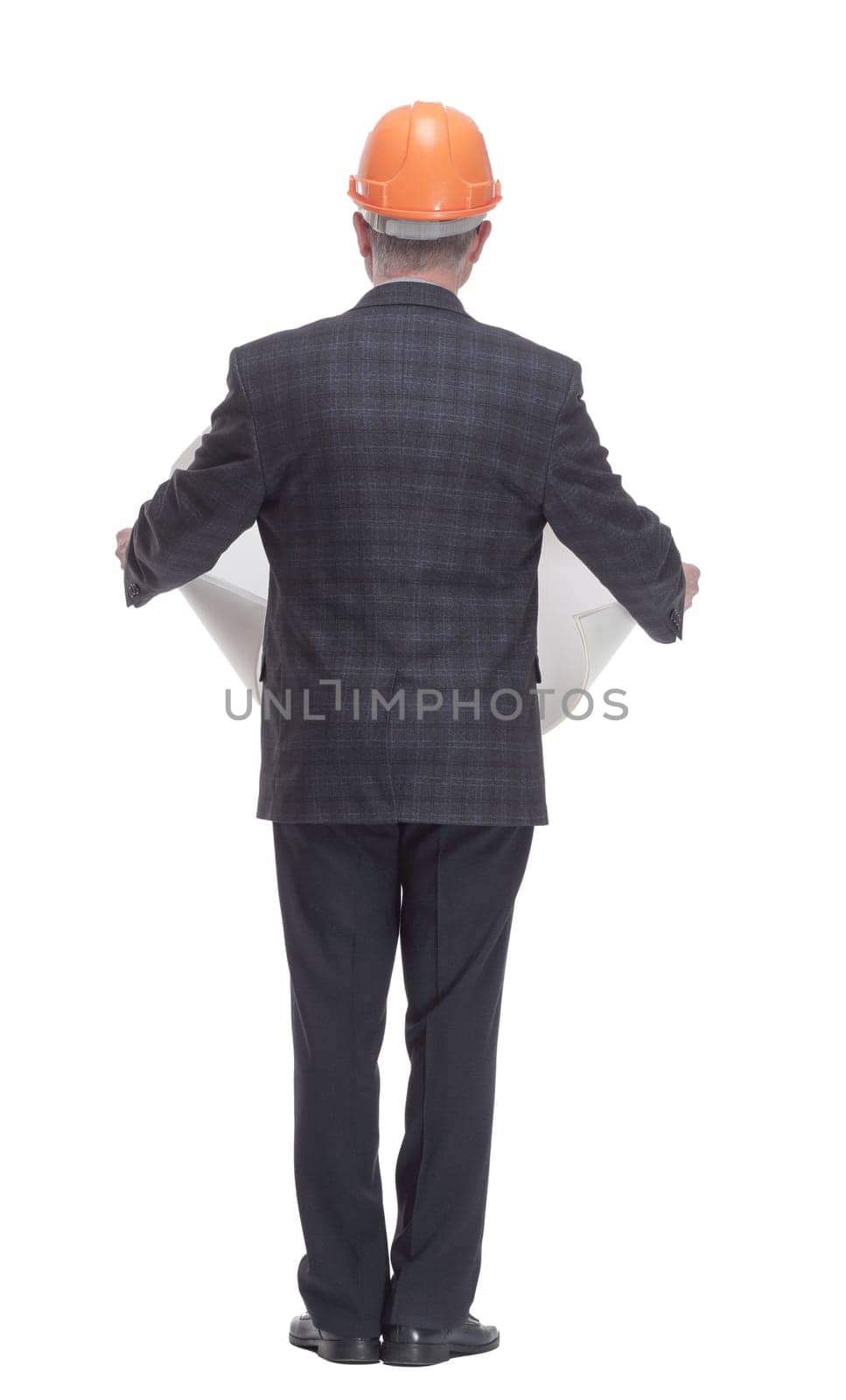 rear view. architect with a drawing standing in front of a white wall. isolated on a white