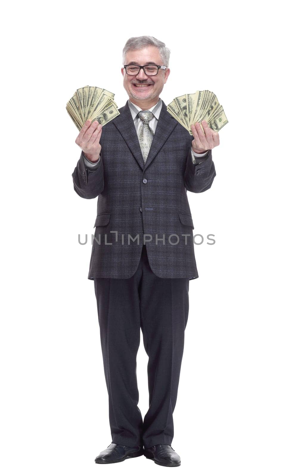 in full growth. happy man with money bills pointing at you. isolated on a white background