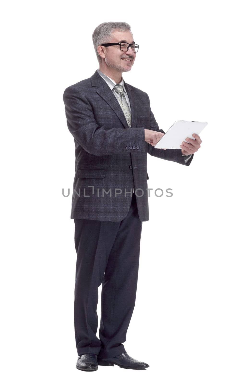 in full growth. smiling man using a digital tablet. isolated on a white background
