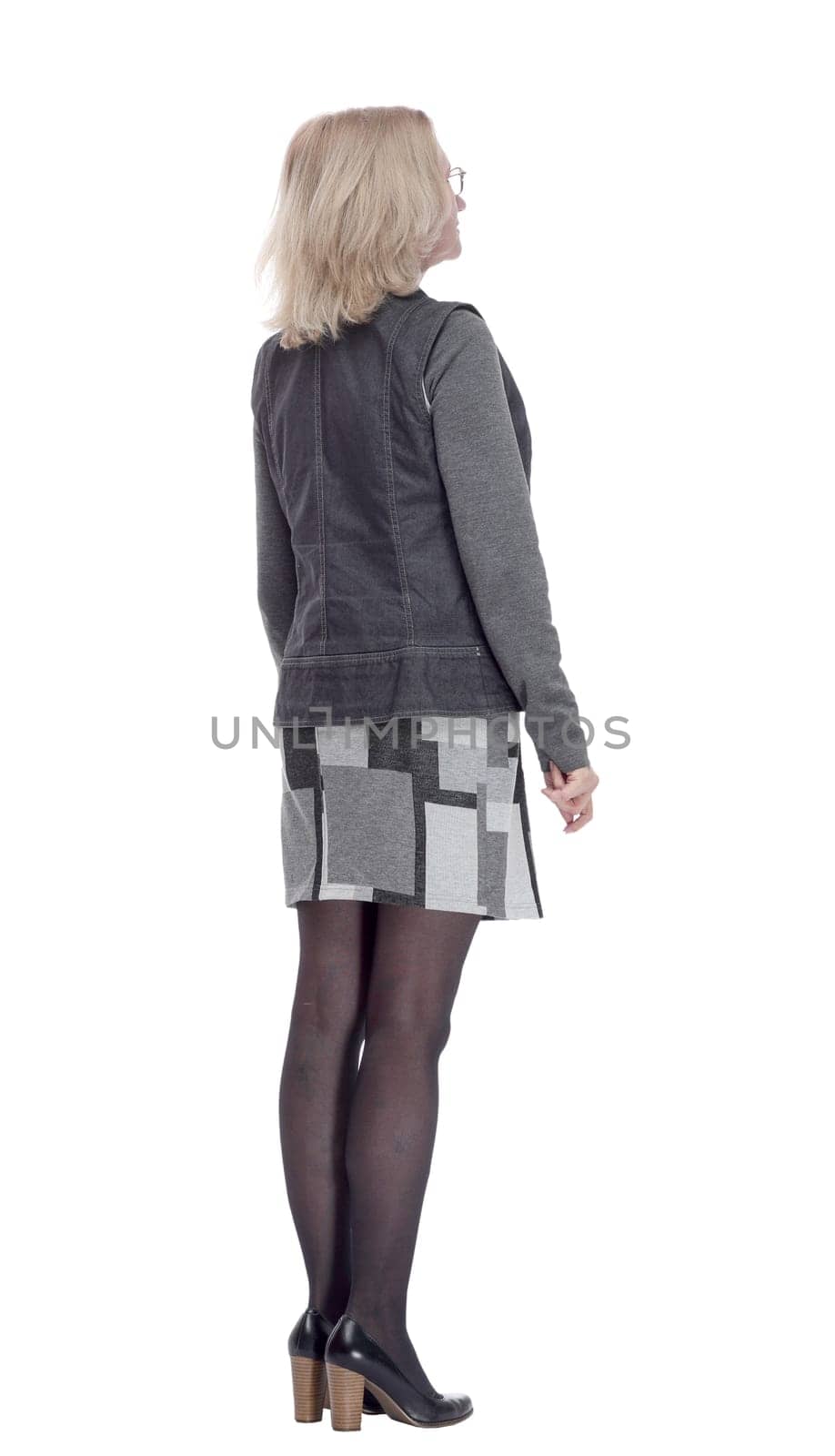side view. casual young woman reading an ad on a white screen . isolated on a white
