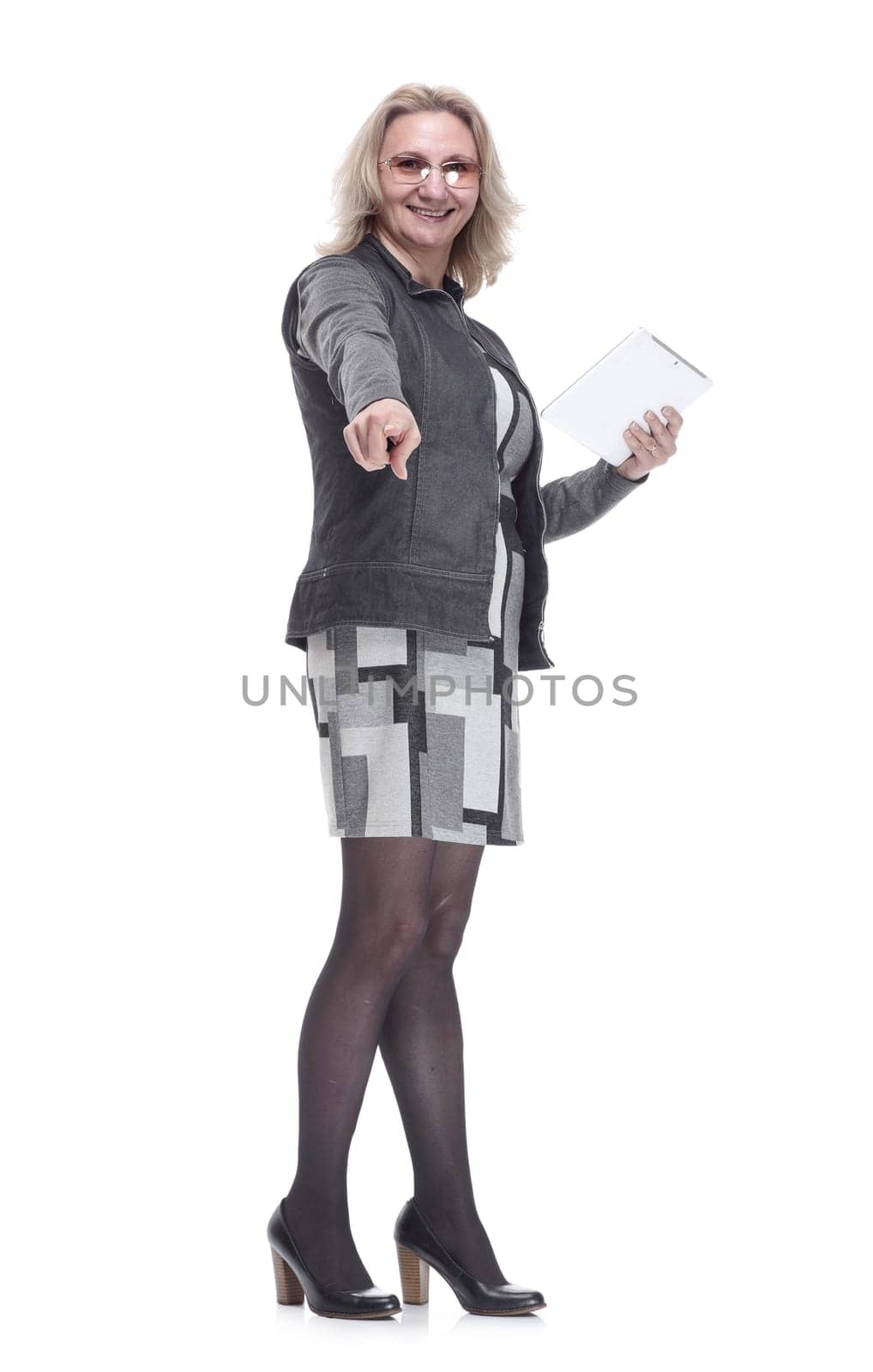in full growth. a contented young woman with a digital tablet pointing at you . isolated on a white