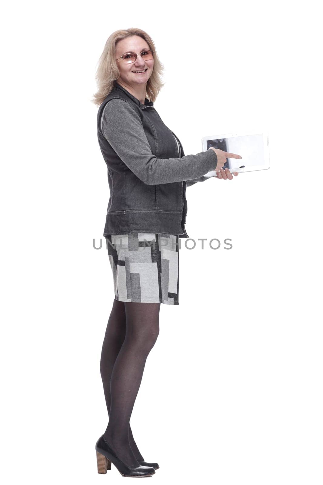side view. casual young woman using a digital tablet . isolated on a white background