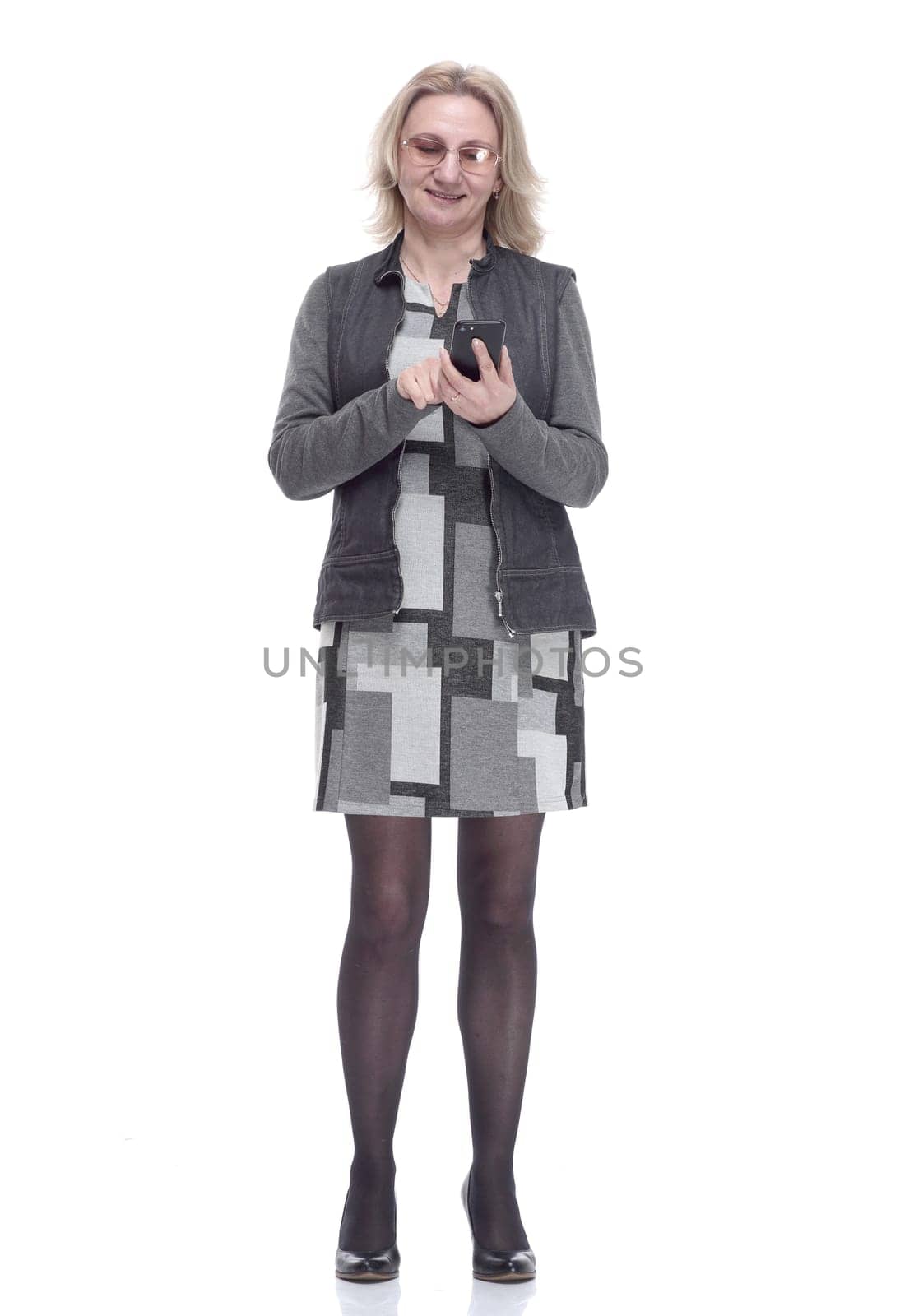 in full growth . casual young woman with a smartphone . isolated on a white background