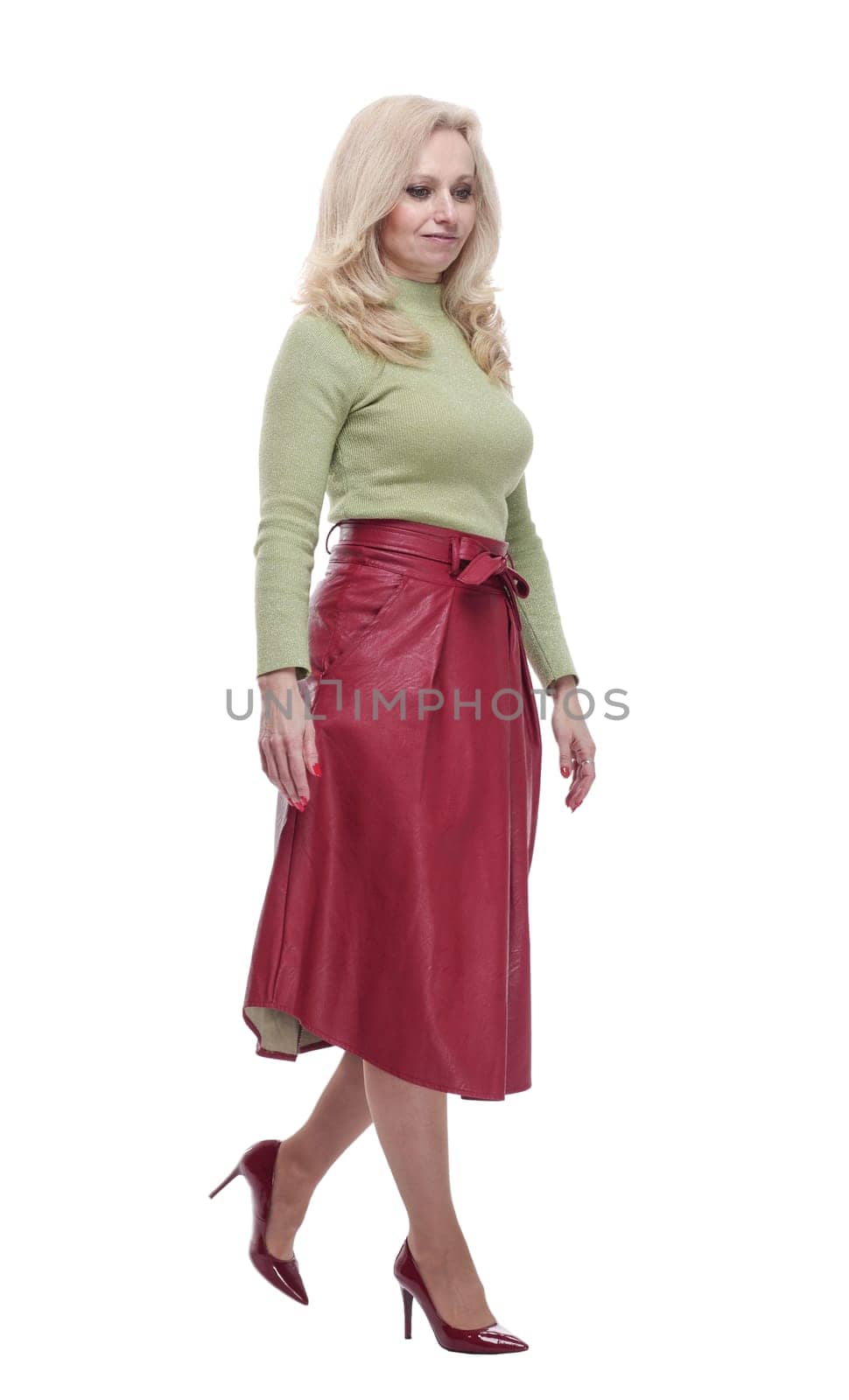 side view. friendly young woman standing in front of a white screen. isolated on a white background