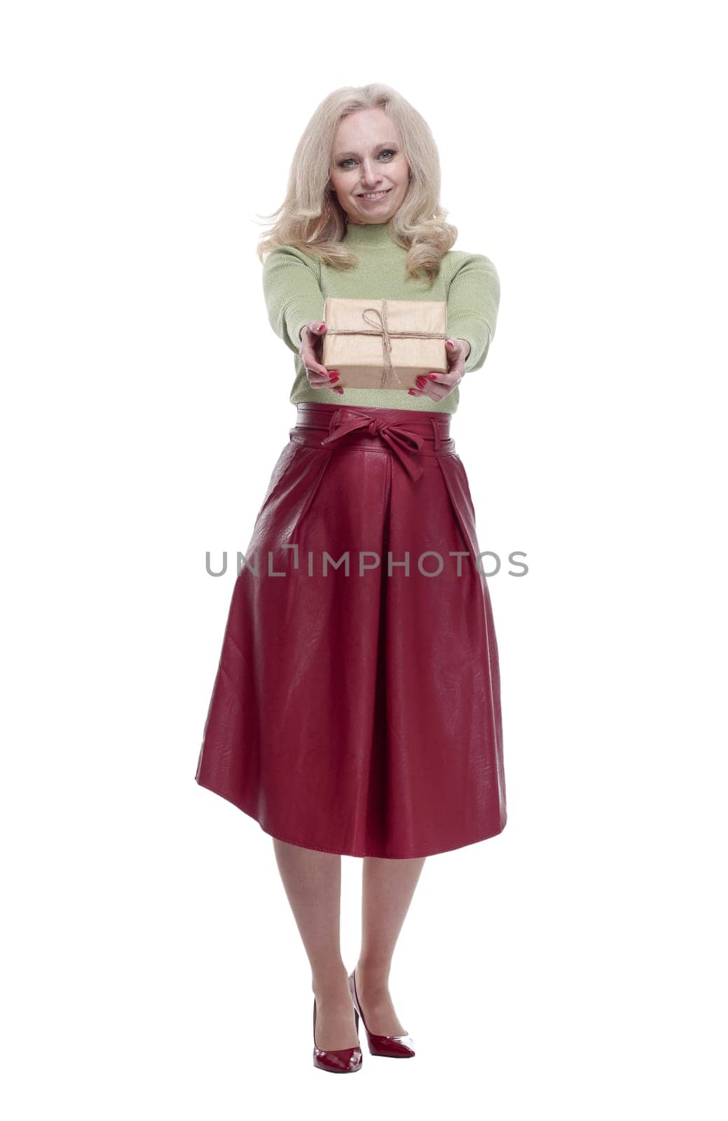 in full growth. elegant woman handing you a gift box . isolated on a white background