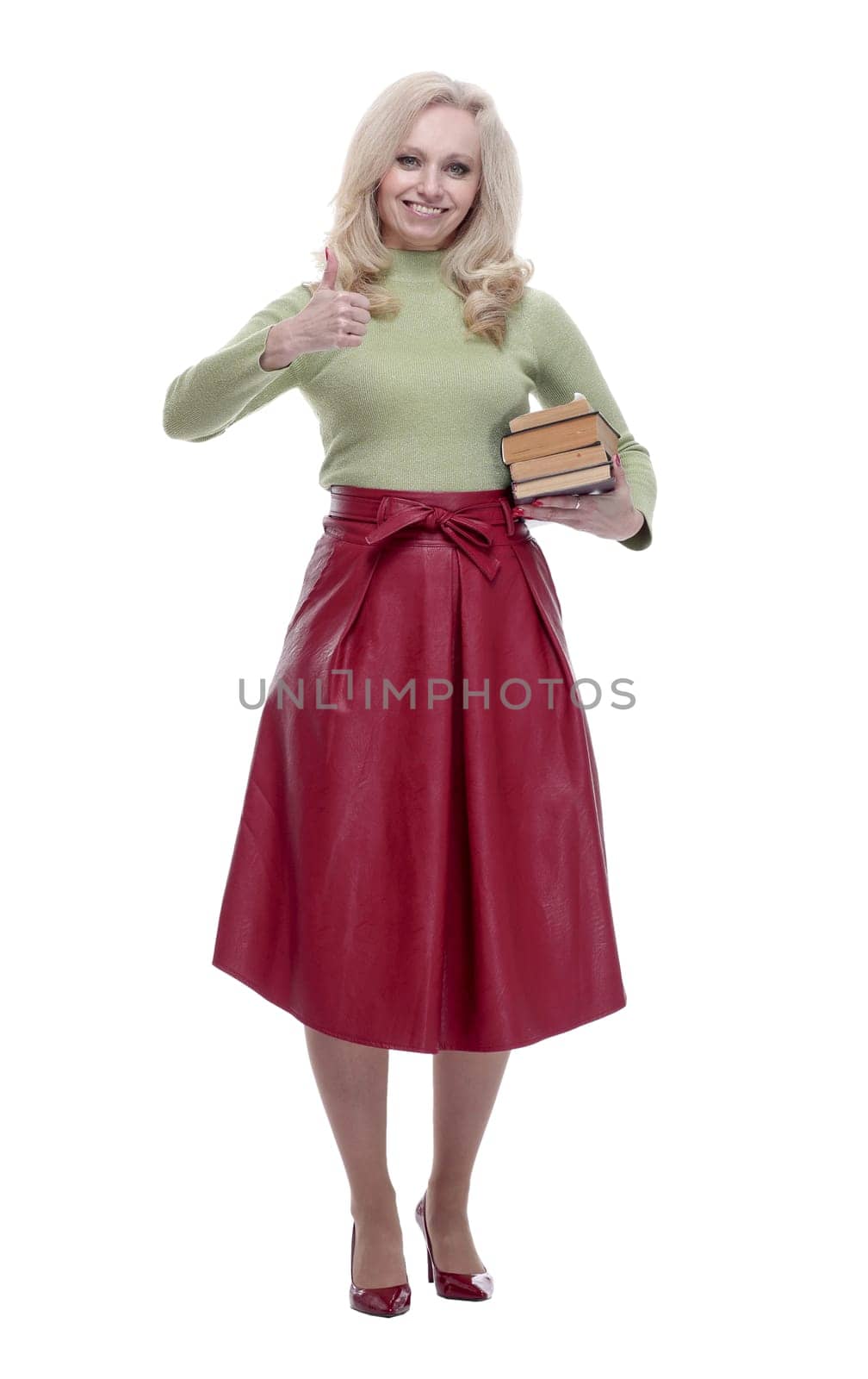 in full growth. happy woman with a stack of books giving a thumbs up . isolated on a white
