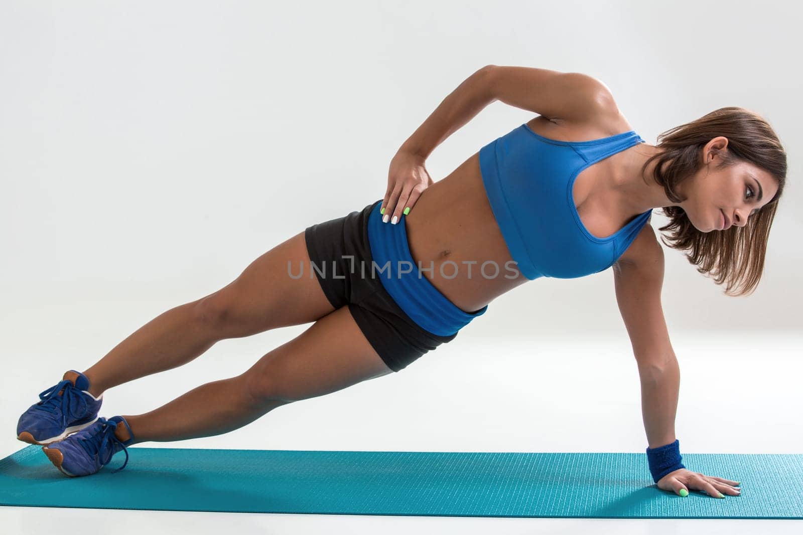 Sporty flexible girl doing stretching exercise by nazarovsergey