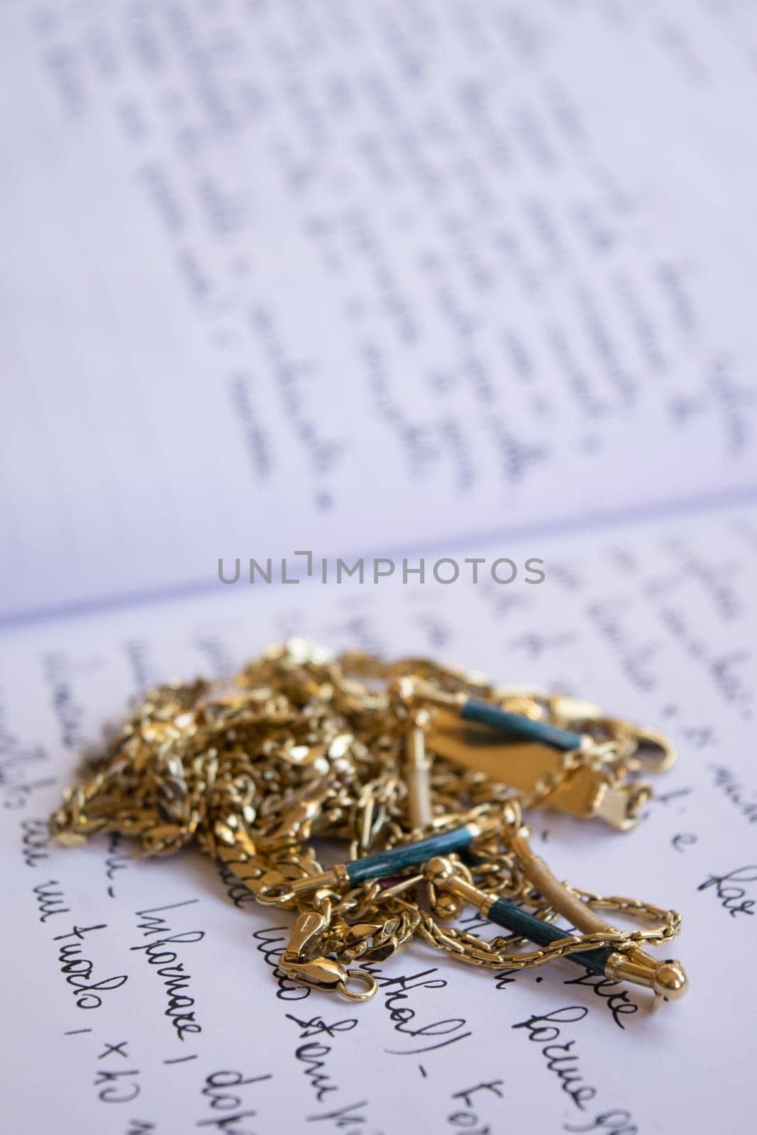 gold jewelry on a handwritten notebook