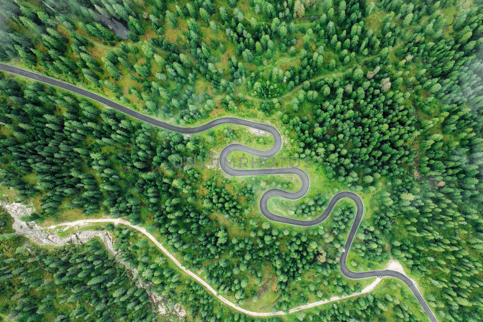 The renowned Snake Road winding through the picturesque Giau Pass, adorned with a breathtaking summer landscape