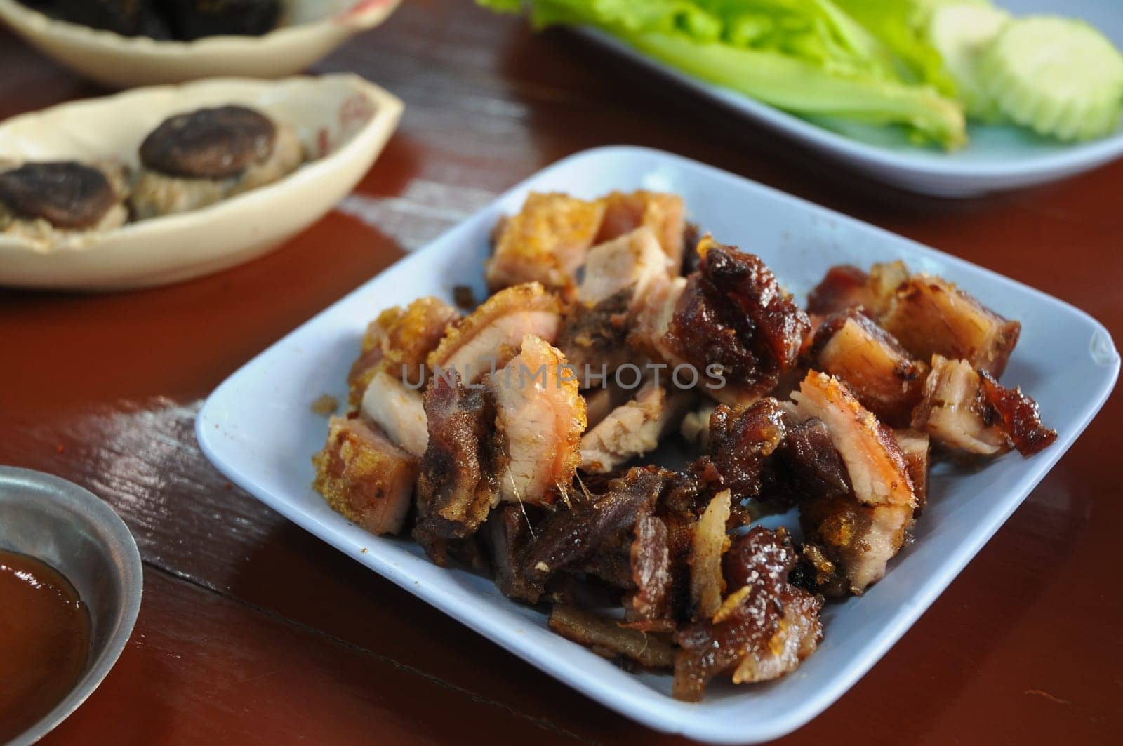 Thai style BBQ Roasted pork in blue dish for lunch by eyeofpaul