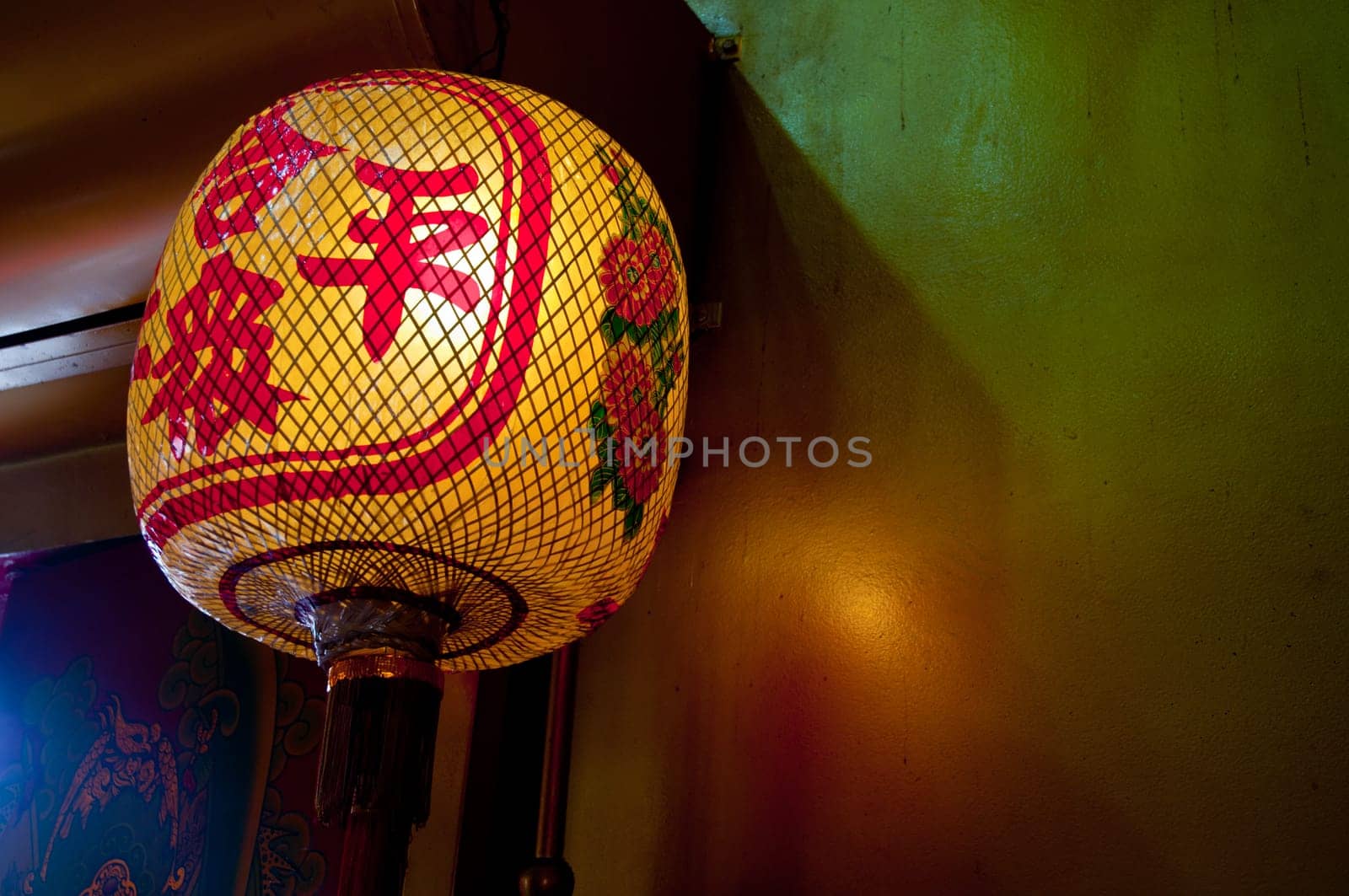 Asian Chinese yellow red traditional lantern hanging on the wall for Chinese New Year celebration by eyeofpaul