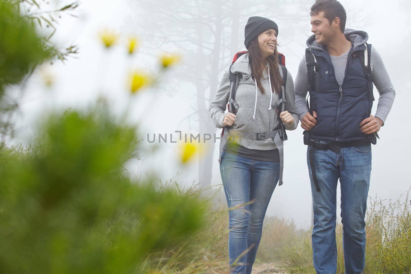 Romance and adventure. a young couple hiking along a nature trail