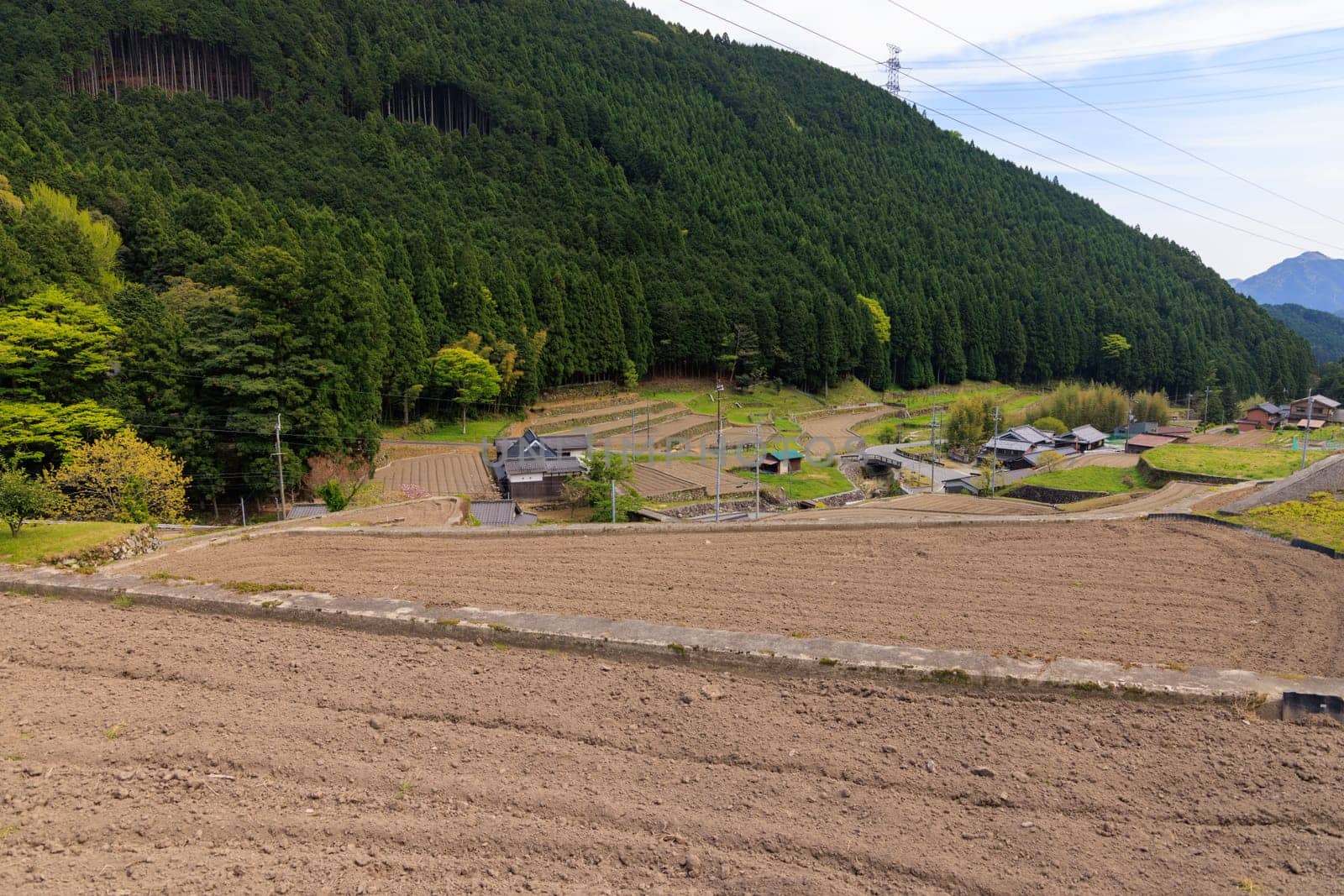 Dry soil in terraced fields over small village in mountains of Japan. High quality photo