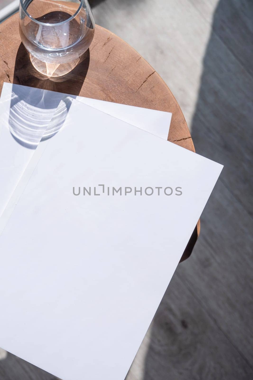 Magazine and book mockup design. Blank magazine on modern wooden table with candles , shadow overlay. Mockup soy wax candle in natural style.