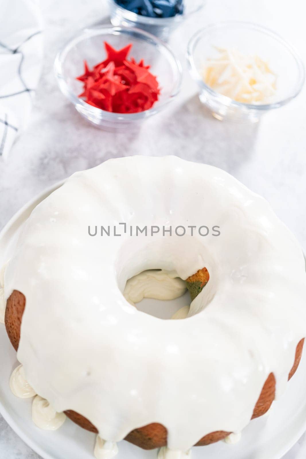 Decorating freshly baked bundt cake with chocolate stars for the July 4th celebration.