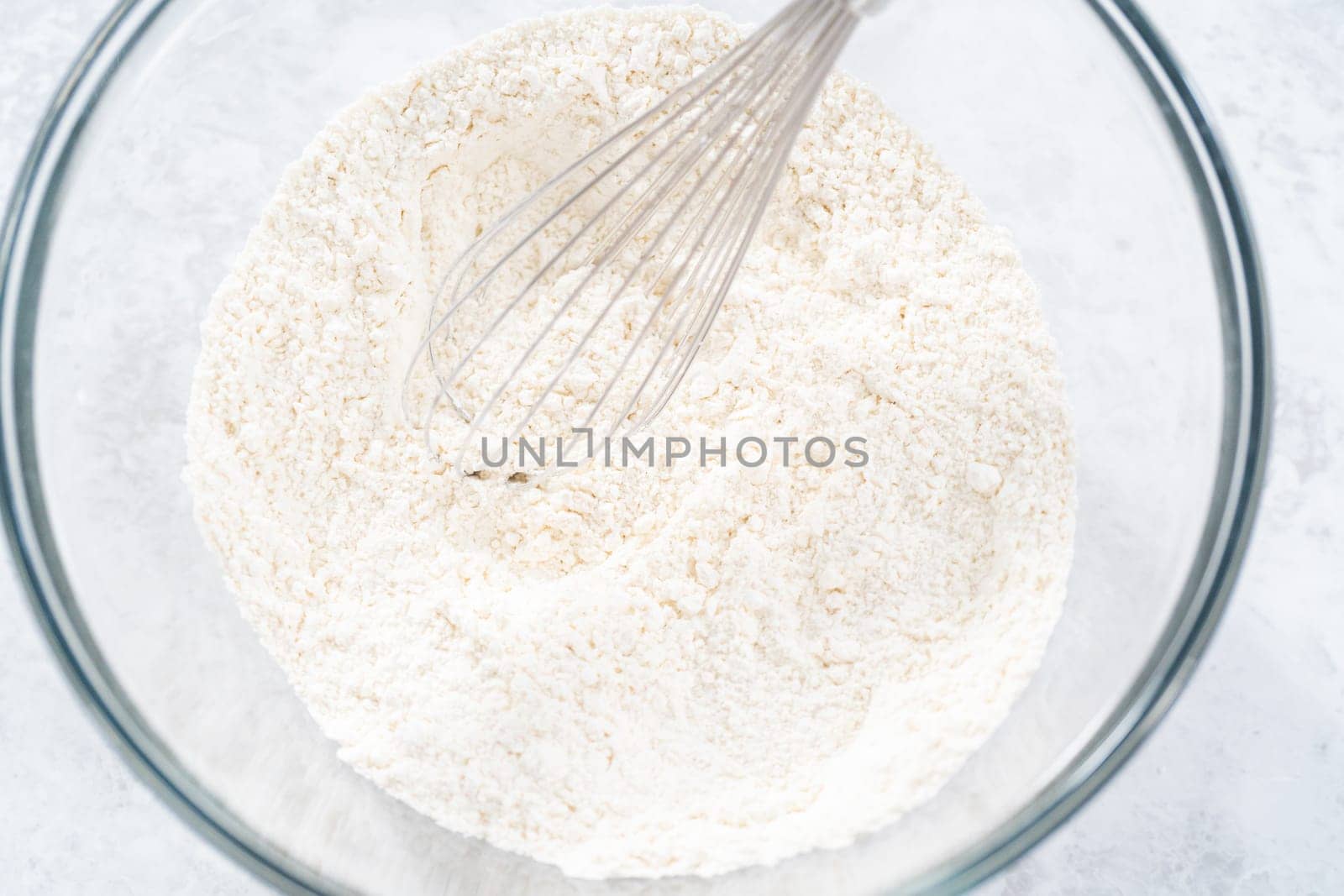 Mixing ingredients in a glass mixing bowl to bake July 4th bundt cake with chocolate stars.