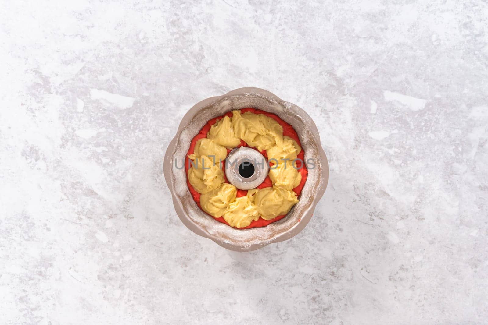 Flat lay. Filling bundt cake pan with red, white, and blue cake dought to bake July 4th bundt cake with chocolate stars.