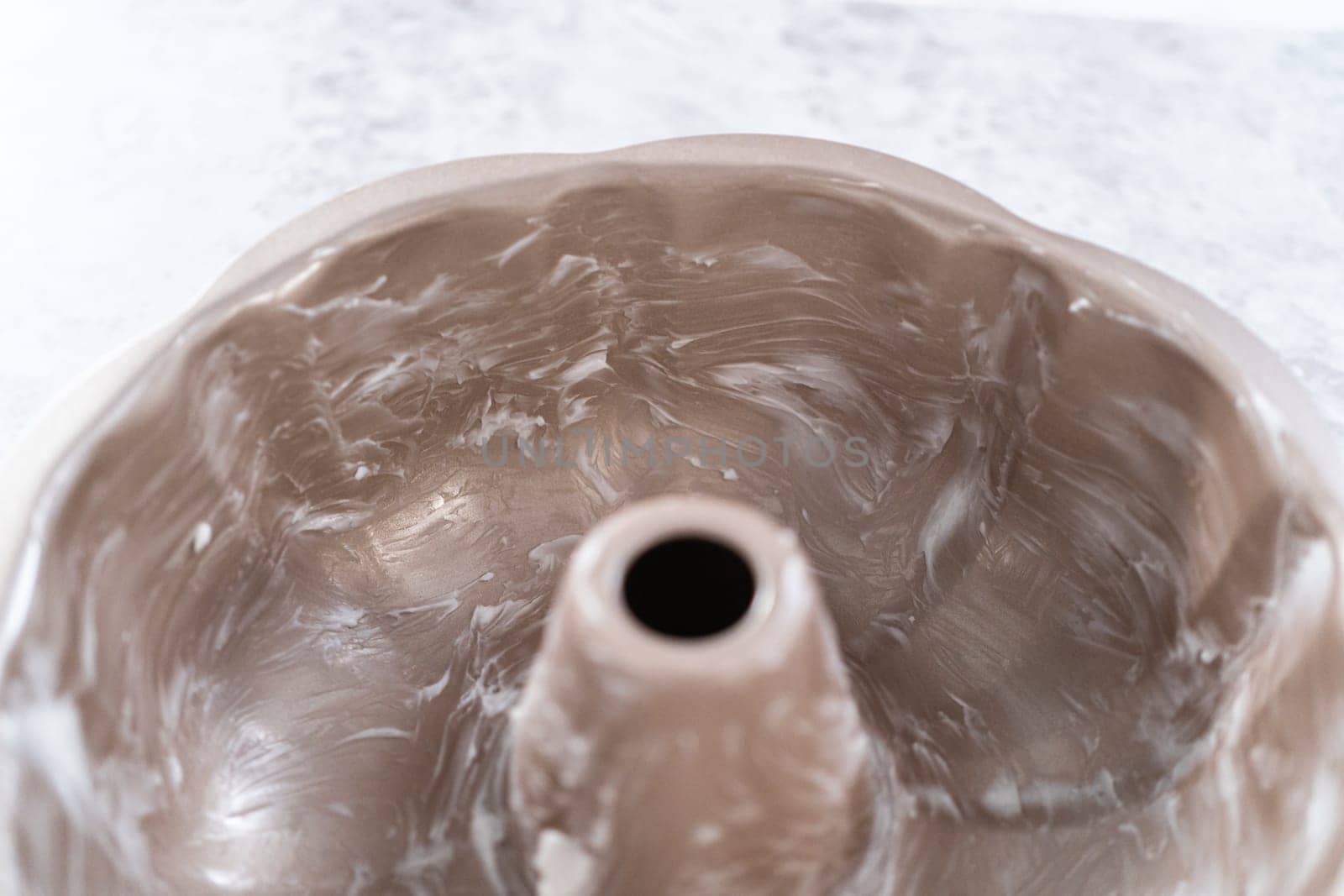 Greasing bundt cake pan to bake July 4th bundt cake with chocolate stars.