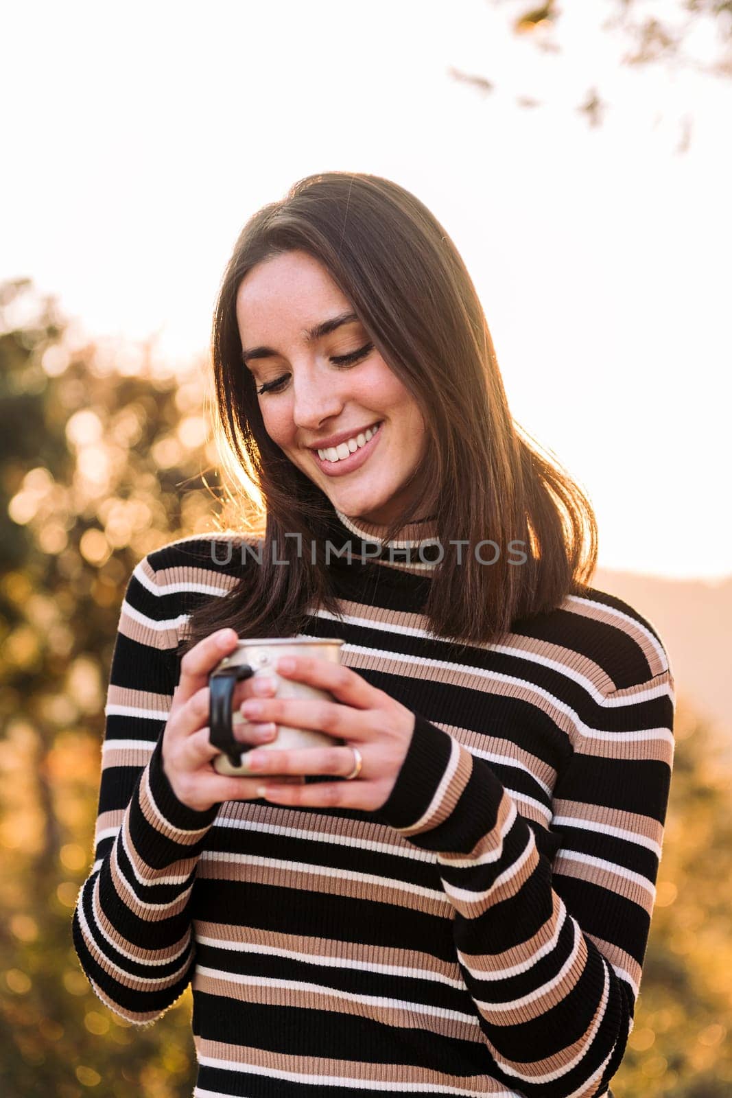 smiling young woman embraces the outdoors finding happiness and joy in the morning, concept of nature's warmth and wilderness lifestyle