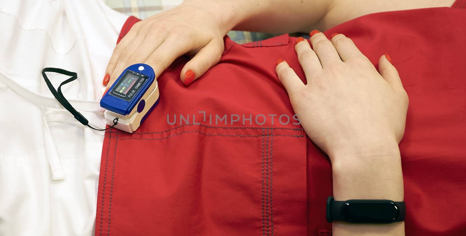 Pulse oximeter on the patient's arm. Surgical equipment. Oxygen saturation in the blood.