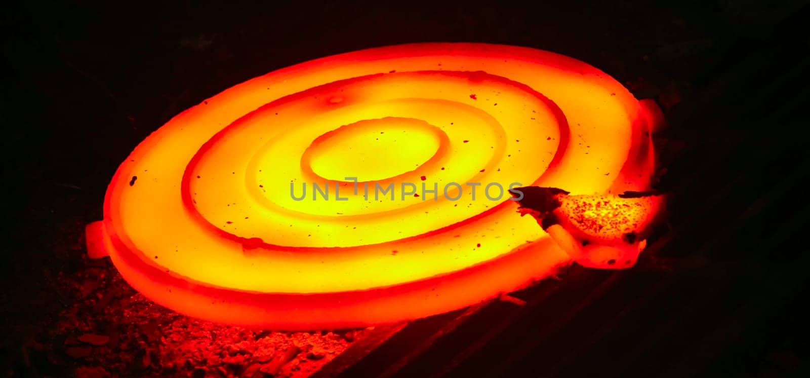 Casting steel at a steel plant. Molten metal was poured from the ladle. Metallurgical production, heavy industry, sewer manhole smelting.