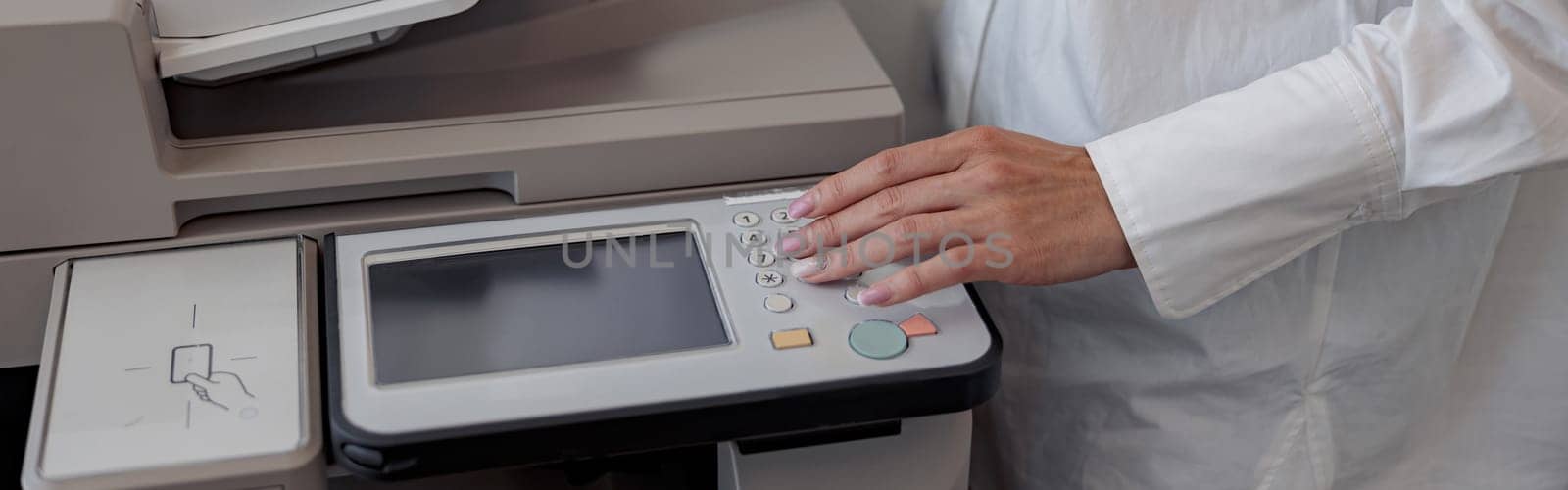 Close up of woman worker scanning a document on photocopy machine In modern office by Yaroslav_astakhov