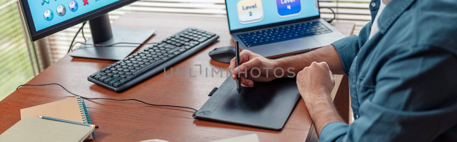 Male designer works in home office drawing on graphic tablet. Freelancer working on project by Yaroslav_astakhov