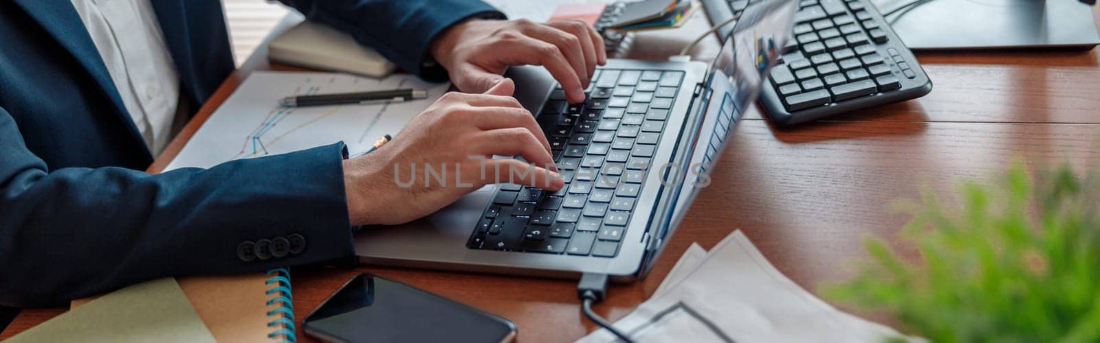 Close up of businessman hands working on laptop in home office. High quality photo