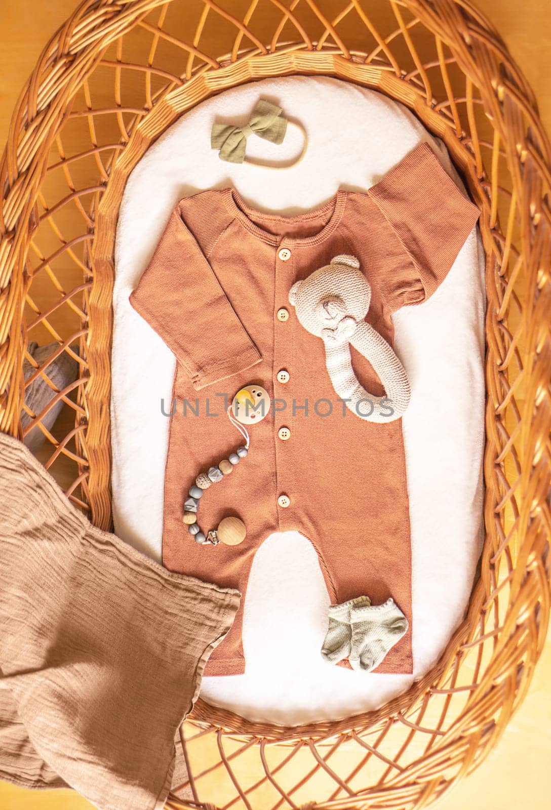 Baby clothes and accessories in basket bassinet. by tanjas_photoarts