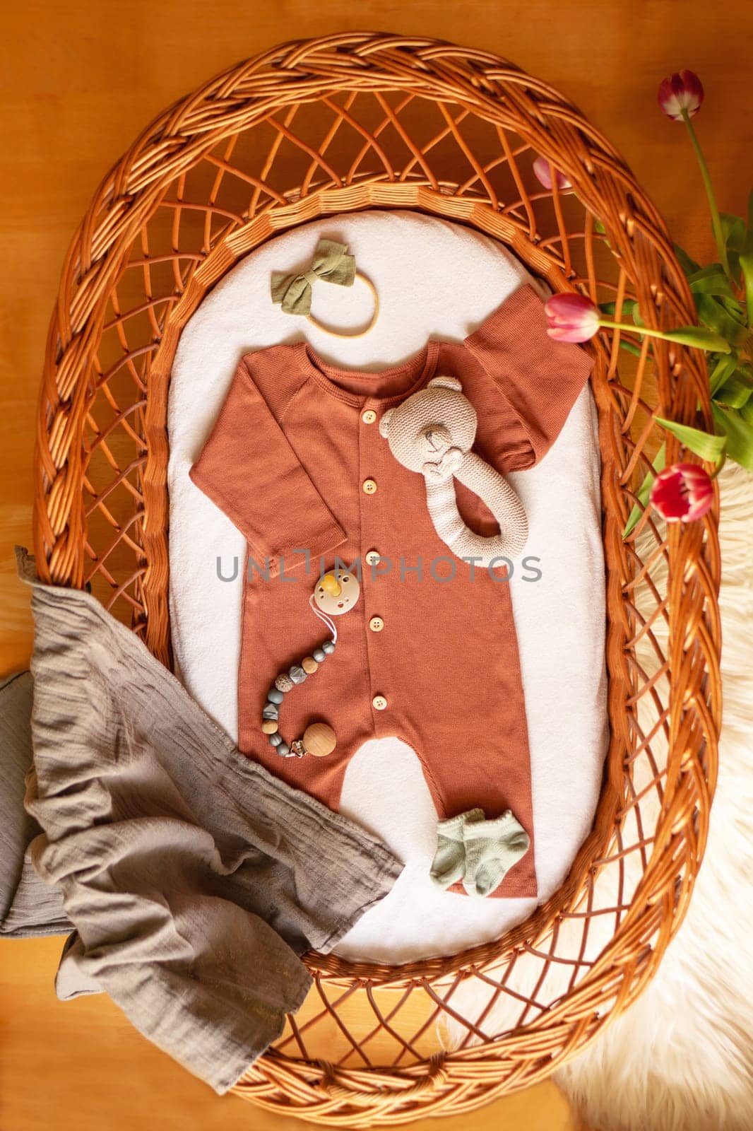 Background of pastel baby clothes and accessories in the basket bassinet. High quality photo
