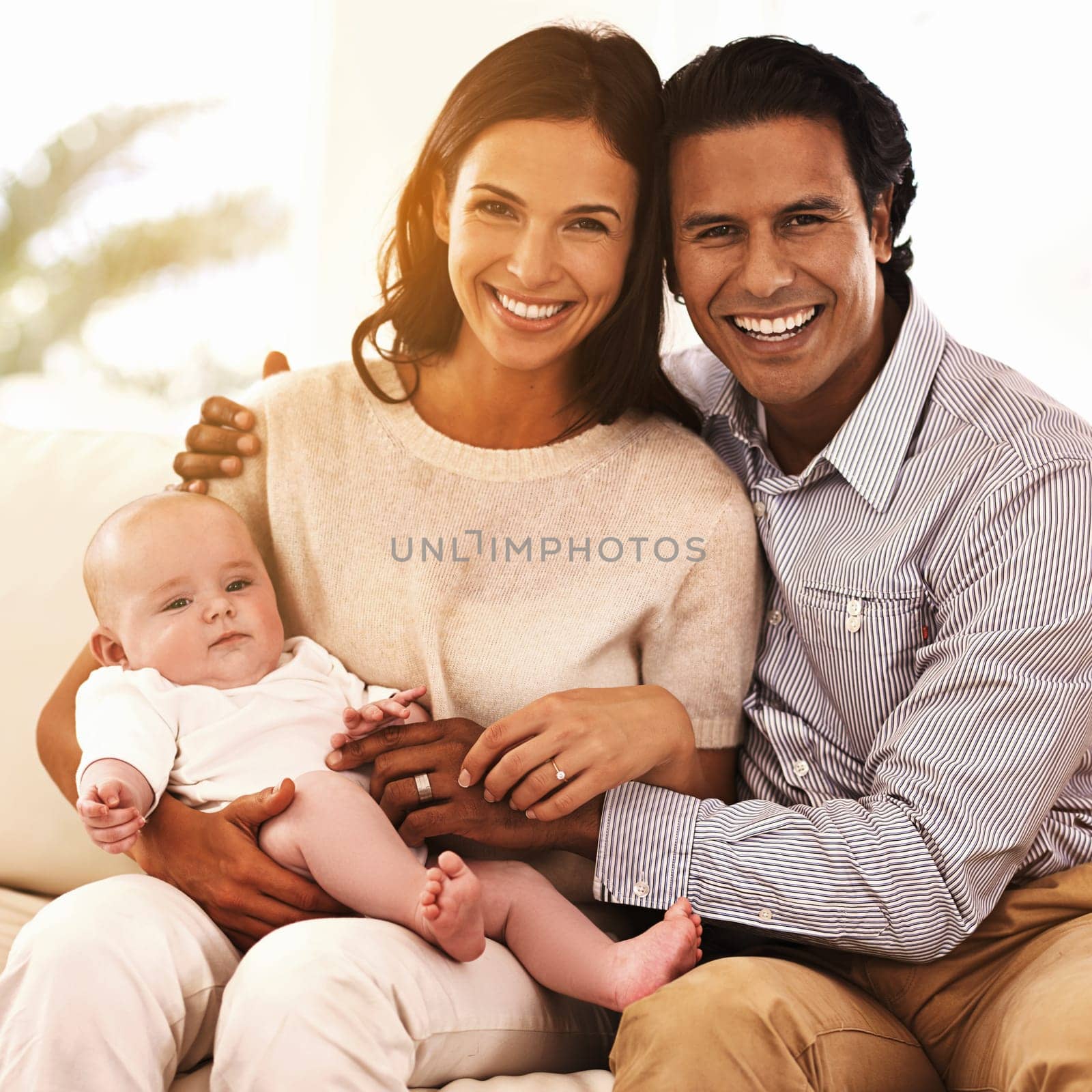 The newest addition to our household. Cropped portrait of an affectionate couple and their newborn baby. by YuriArcurs