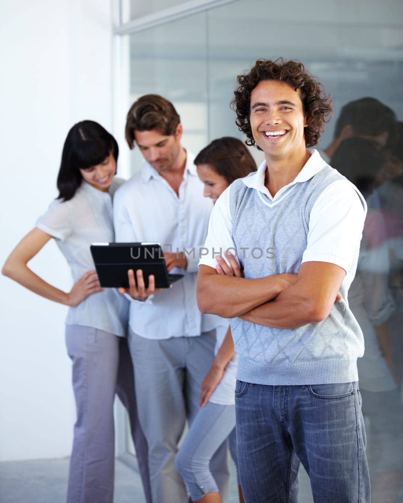 Leader, smile and portrait of a businessman in leadership at a digital agency or company with arms crossed. Planning, tablet and manager with a his team in a meeting and discussion strategy.