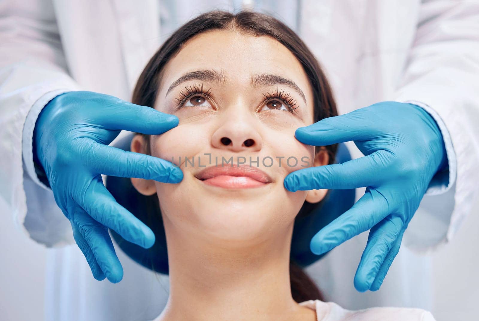 What would you like done. a dentist pinching a patients cheeks