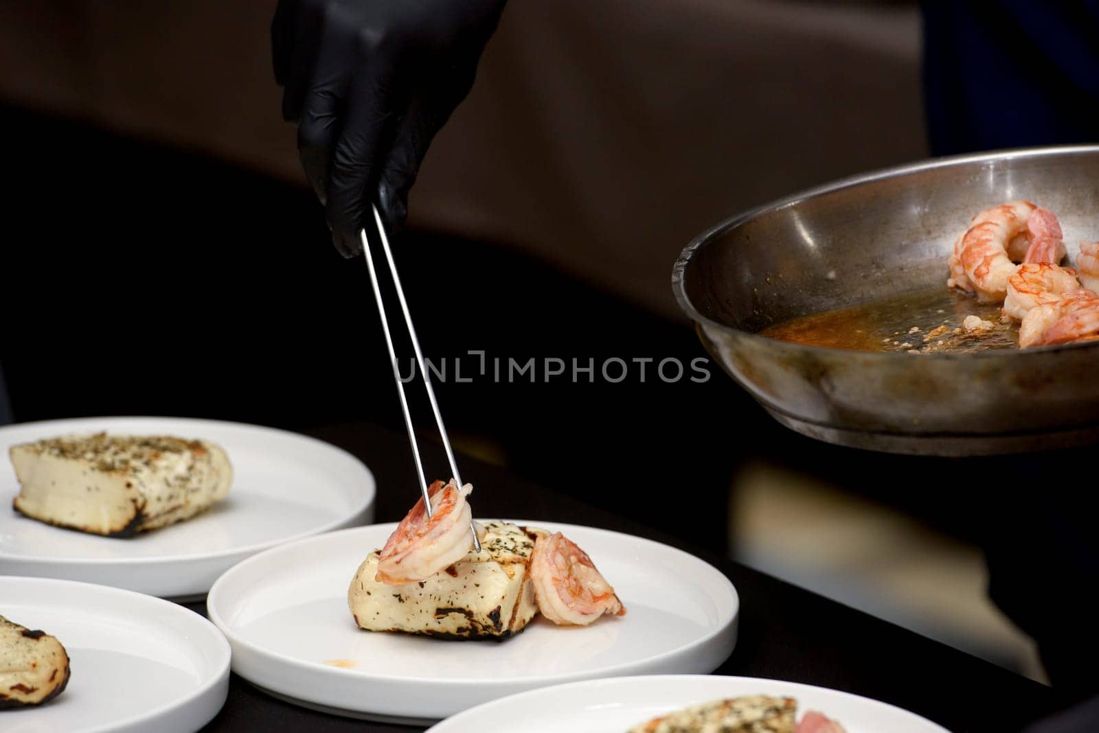 chef in the restaurant serving saganaki, traditional Greek cheese snack that is fried in a pan or grilled by Ashtray25