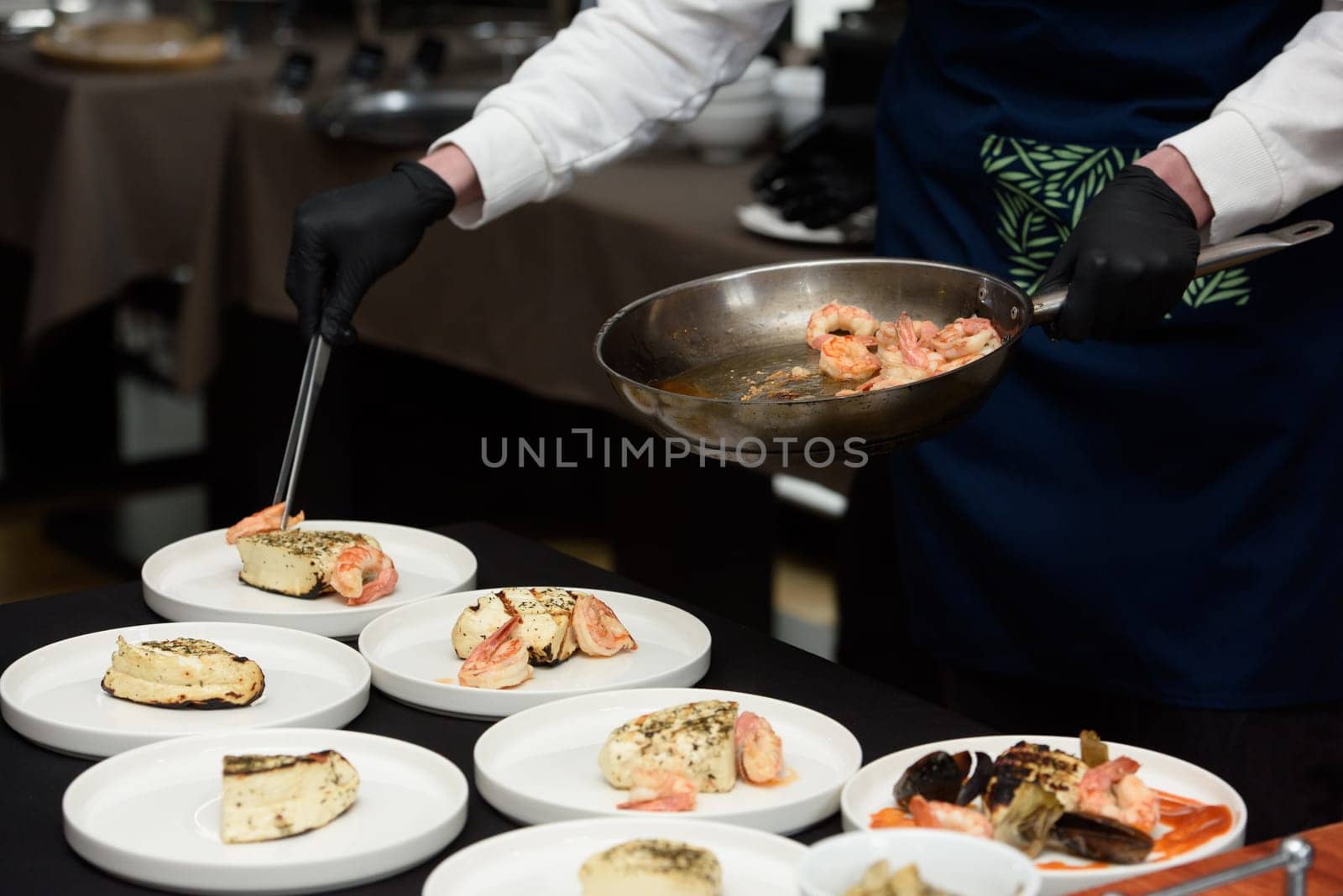 chef in the restaurant prepares saganaki, traditional Greek cheese snack that is fried in a pan or grilled by Ashtray25